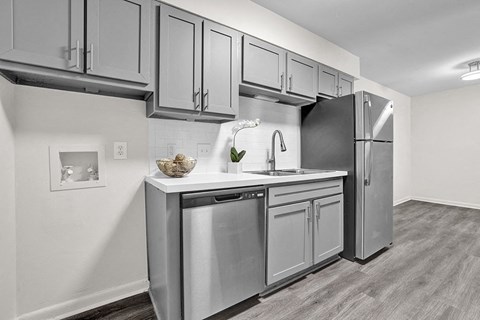 a kitchen with stainless steel appliances and white cabinets